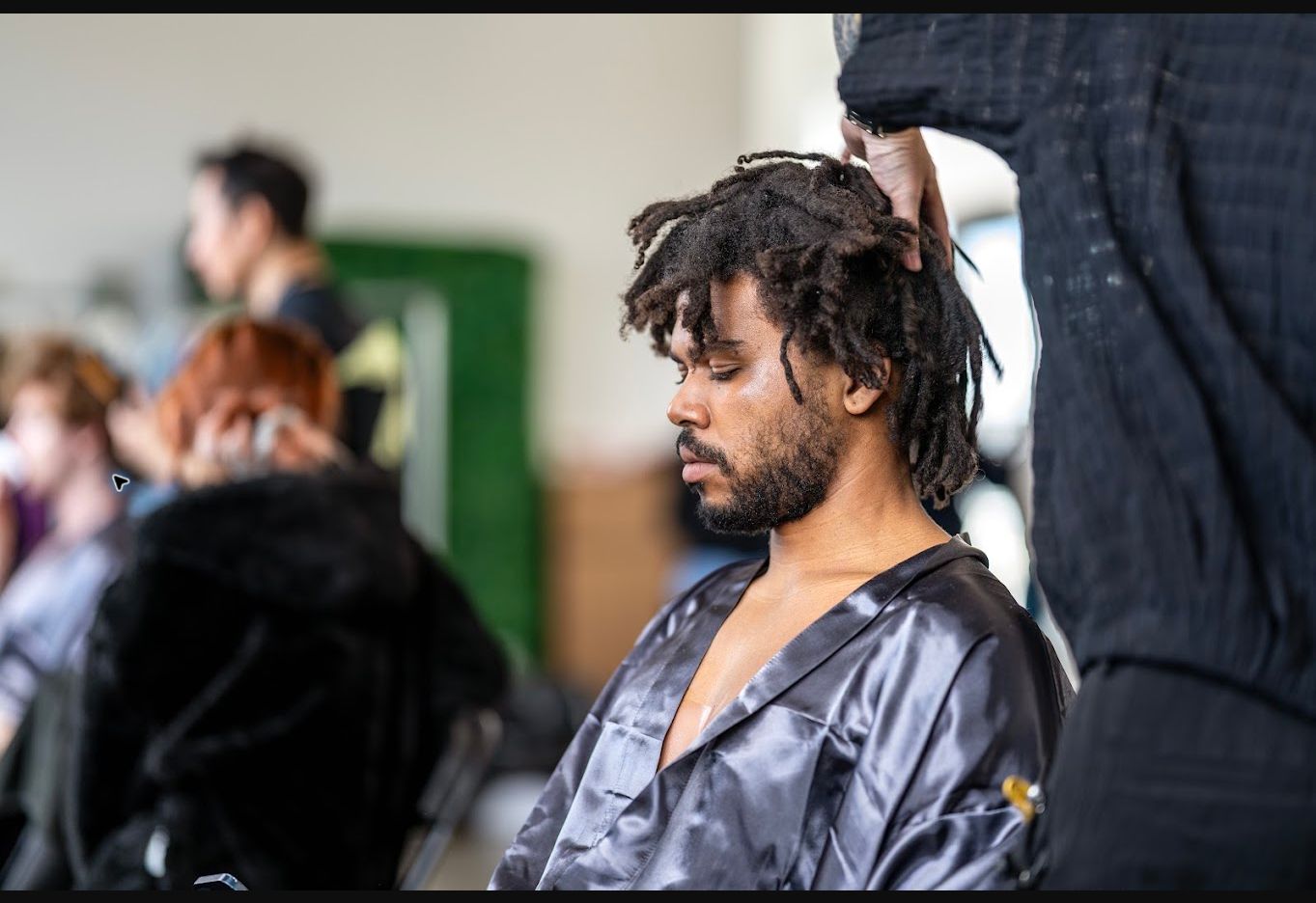 Man preparing backstage at a fashion event