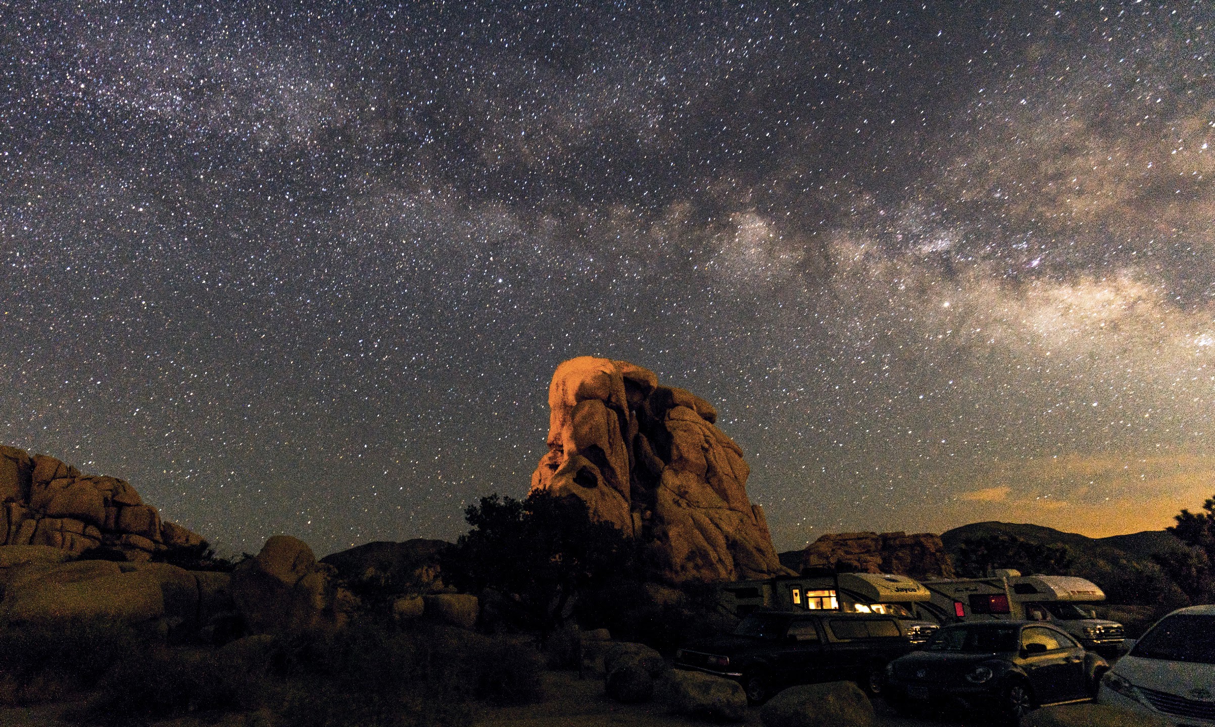 Desert rock formation beneath the Milky Way and a star-filled sky